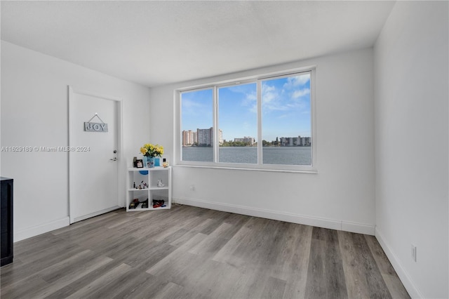 1140 NE 191st St Unit D24, Miami, FL 33179 - unfurnished room featuring light hardwood / wood-style flooring and a water view