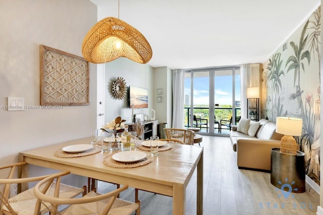 dining room featuring light hardwood / wood-style floors, floor to ceiling windows, and french doors