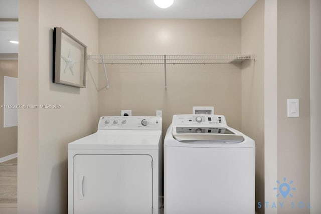 washroom featuring laundry area and washing machine and clothes dryer