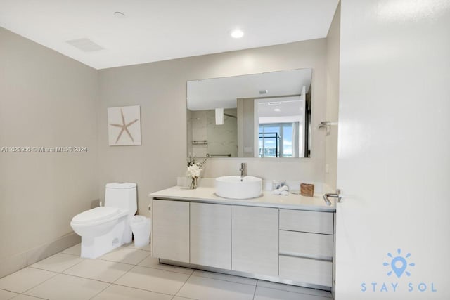 bathroom featuring tile patterned flooring, toilet, visible vents, vanity, and baseboards