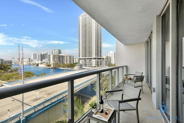 balcony with a view of city and a water view