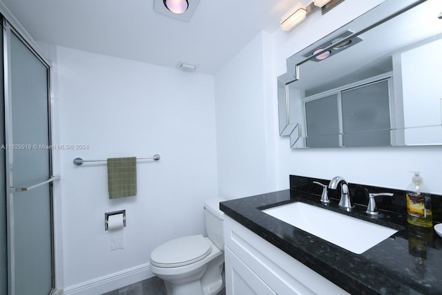 bathroom with vanity, toilet, and walk in shower