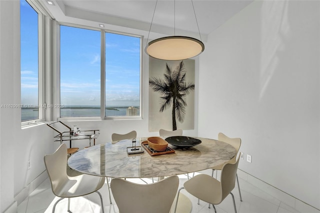 dining space featuring a water view