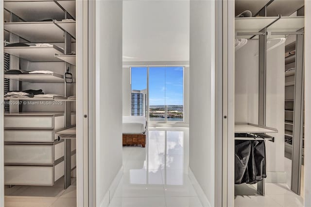 spacious closet featuring light tile patterned flooring