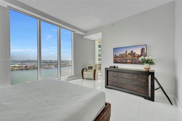 tiled bedroom with a wall of windows