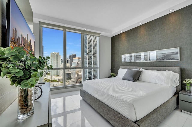 tiled bedroom featuring a wall of windows