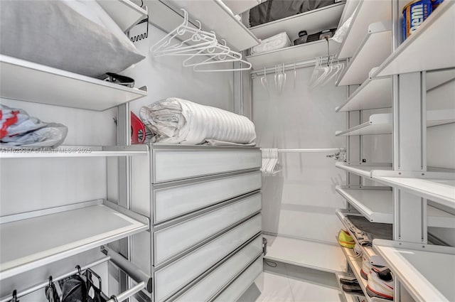 walk in closet featuring light tile patterned flooring