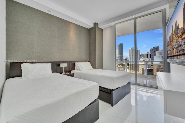 tiled bedroom with a wall of windows and access to outside