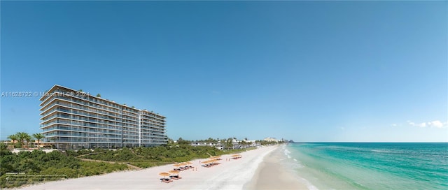 view of road featuring a beach view and a water view