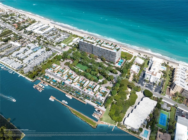 birds eye view of property featuring a water view and a beach view