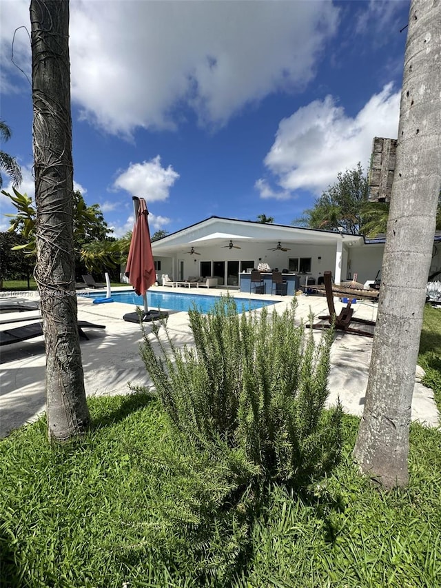 view of swimming pool featuring a patio and ceiling fan