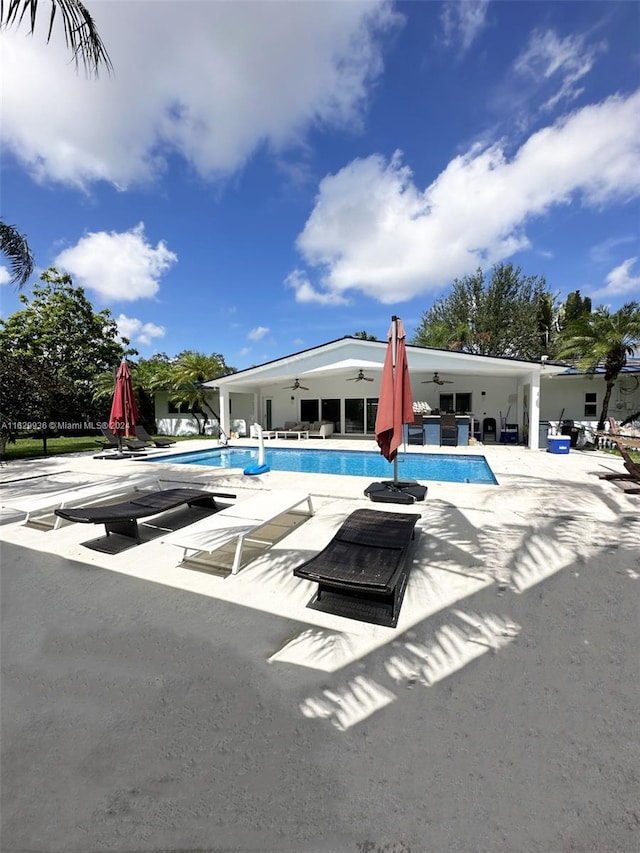 view of pool with ceiling fan and a patio area