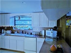 kitchen featuring white appliances and white cabinetry