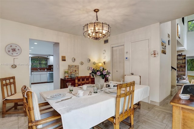 dining area featuring a wealth of natural light, an inviting chandelier, and sink