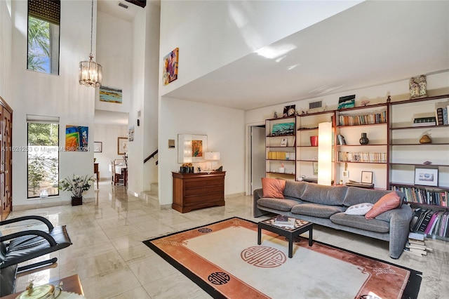 living room with a chandelier and a high ceiling