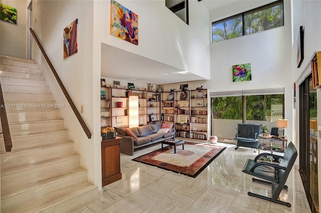 living room featuring a towering ceiling