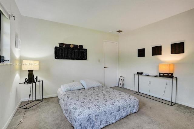 bedroom featuring light colored carpet