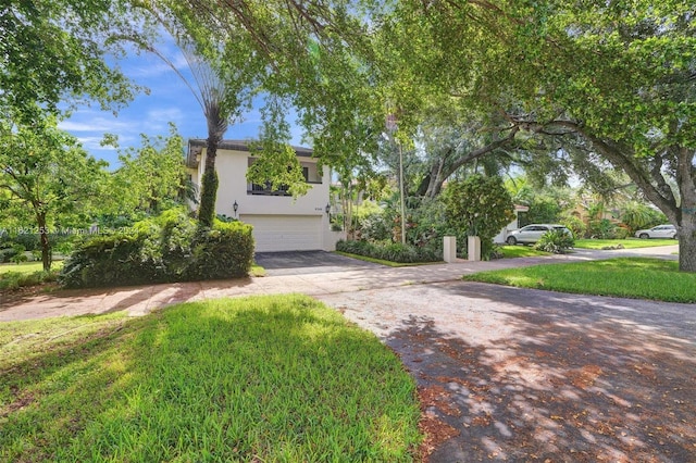 view of front facade with a garage and a front yard