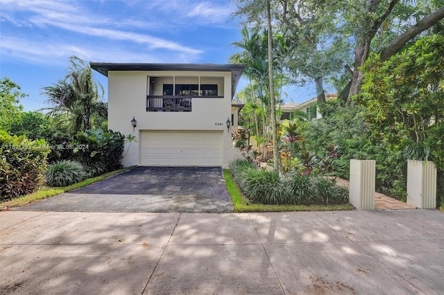 view of front of house featuring a balcony and a garage