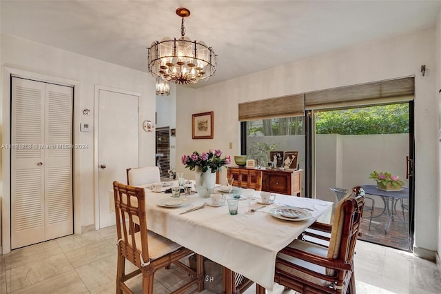 dining room featuring a notable chandelier and light tile patterned flooring