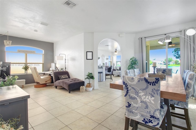 dining space with light tile patterned floors and ceiling fan