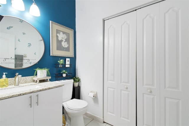 bathroom featuring tile patterned floors, vanity, and toilet