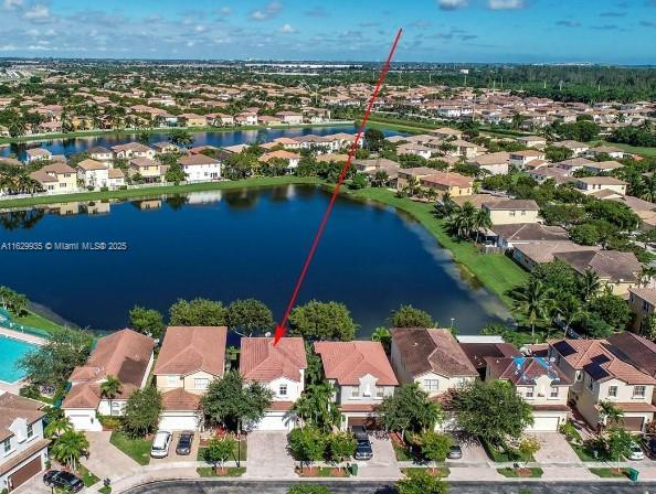 birds eye view of property with a water view