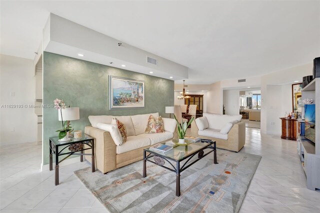 tiled living room featuring a chandelier