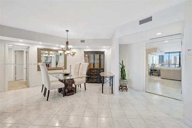 dining room with an inviting chandelier and light tile patterned flooring