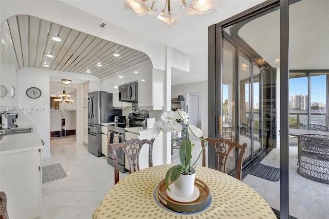 dining room featuring a notable chandelier and sink