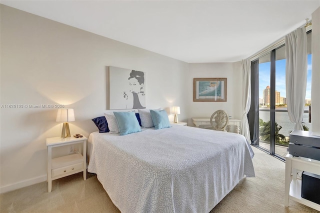 carpeted bedroom with access to outside and a wall of windows