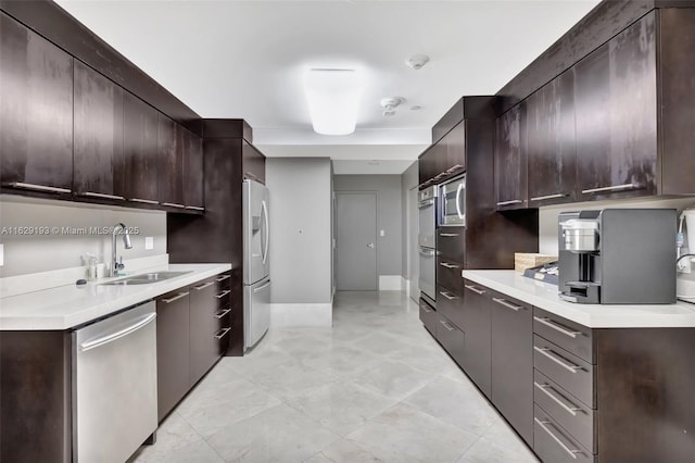 kitchen with appliances with stainless steel finishes, sink, and dark brown cabinets