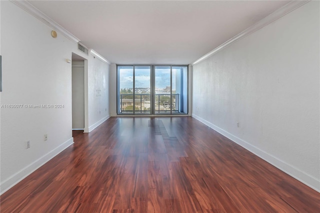 unfurnished room featuring expansive windows, crown molding, and dark wood-type flooring