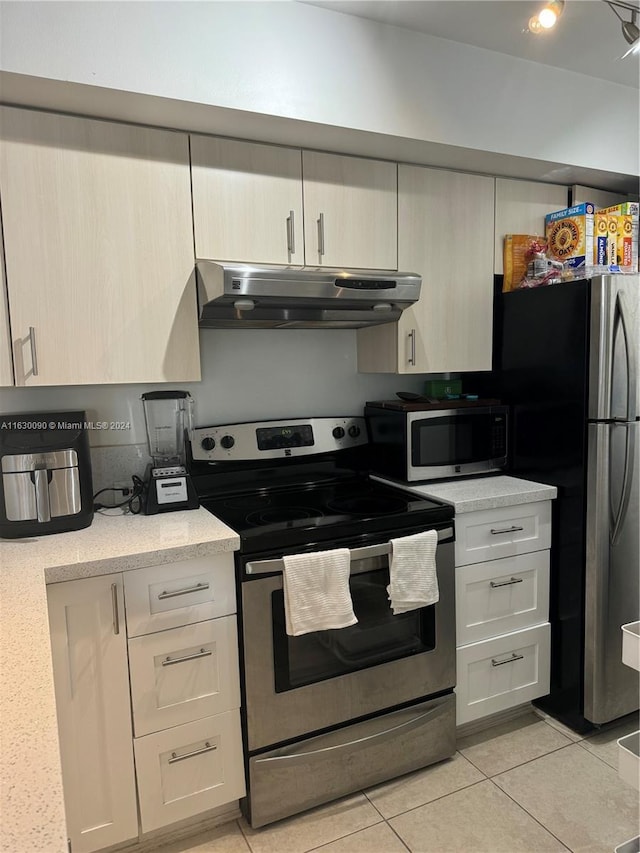 kitchen featuring light tile patterned flooring and appliances with stainless steel finishes