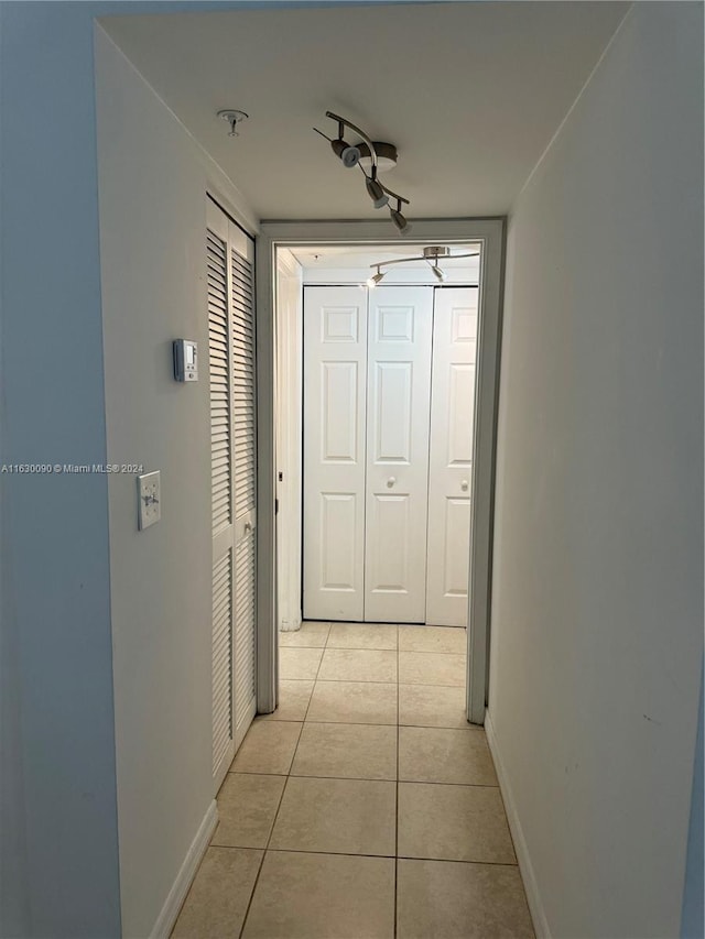 corridor featuring light tile patterned floors