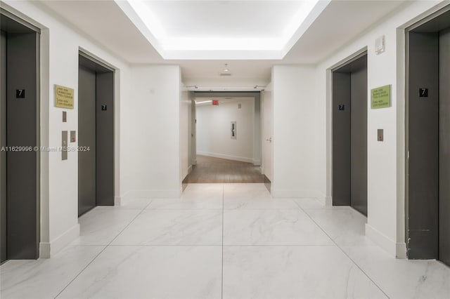 3301 NE 1st Ave Unit M0705, Miami, FL 33137 - corridor featuring baseboards, a tray ceiling, and elevator