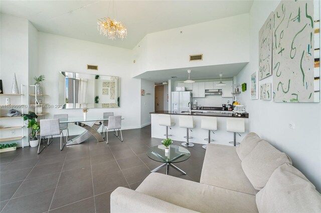 3301 NE 1st Ave Unit M0705, Miami, FL 33137 - living area with dark tile patterned floors, a high ceiling, visible vents, and a notable chandelier