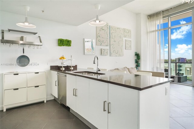 3301 NE 1st Ave Unit M0705, Miami, FL 33137 - kitchen featuring a peninsula, dark tile patterned floors, a sink, dishwasher, and dark countertops