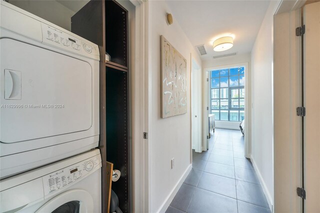 3301 NE 1st Ave Unit M0705, Miami, FL 33137 - clothes washing area with stacked washer / dryer, laundry area, tile patterned flooring, and baseboards