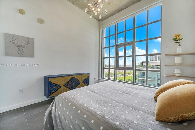 3301 NE 1st Ave Unit M0705, Miami, FL 33137 - tiled bedroom with a towering ceiling and baseboards