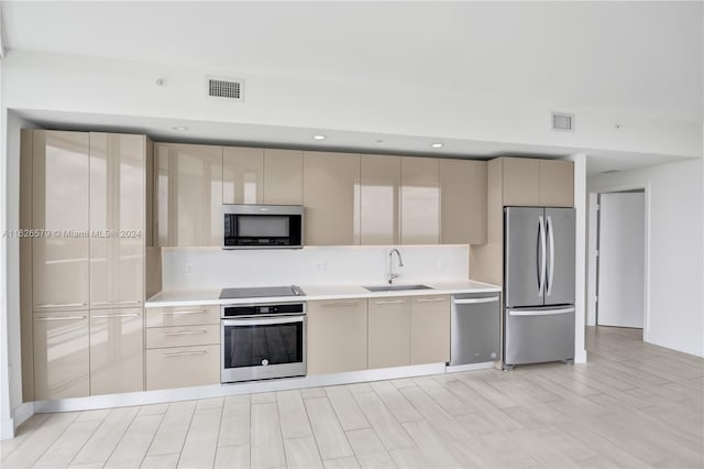 kitchen featuring sink, appliances with stainless steel finishes, and light wood-type flooring