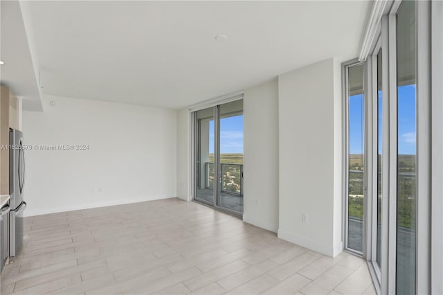 unfurnished room with floor to ceiling windows