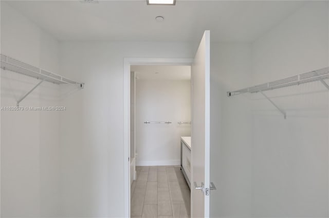 spacious closet featuring light tile patterned floors