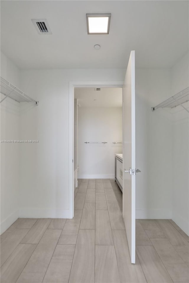 spacious closet featuring light tile patterned floors