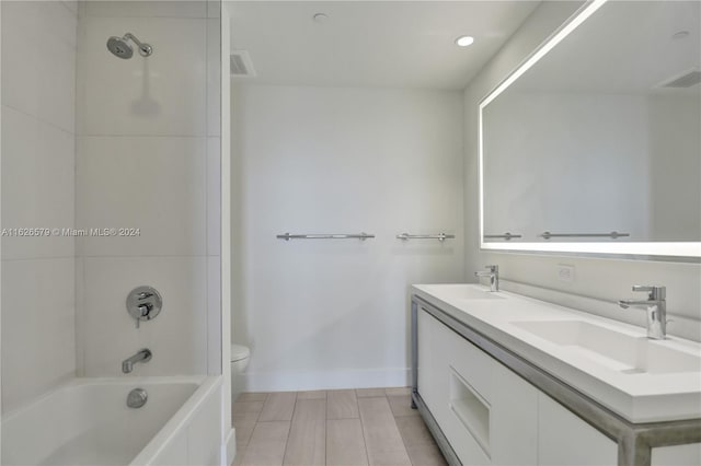 full bathroom featuring dual vanity, shower / washtub combination, tile patterned flooring, and toilet