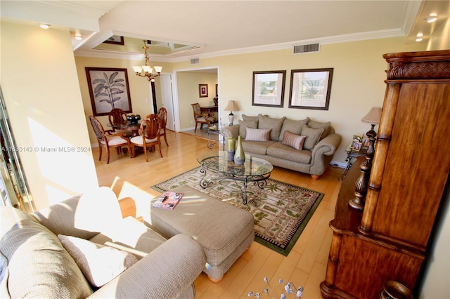900 Bay Dr Unit 319, Miami Beach, FL 33141 - living room with crown molding, a chandelier, and light wood-style floors