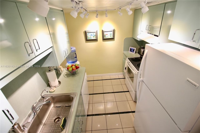 900 Bay Dr Unit 319, Miami Beach, FL 33141 - kitchen with white appliances, track lighting, light tile patterned floors, and green cabinets