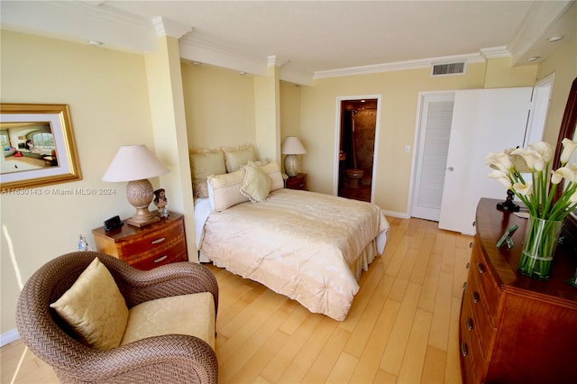 bedroom with light hardwood / wood-style floors and ornamental molding