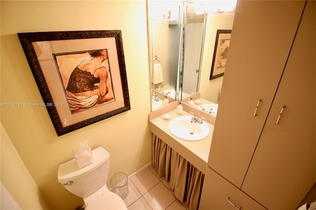 bathroom with vanity, tile patterned floors, and toilet