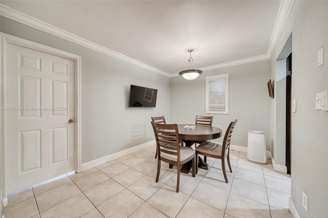 dining space featuring ornamental molding and light tile patterned floors